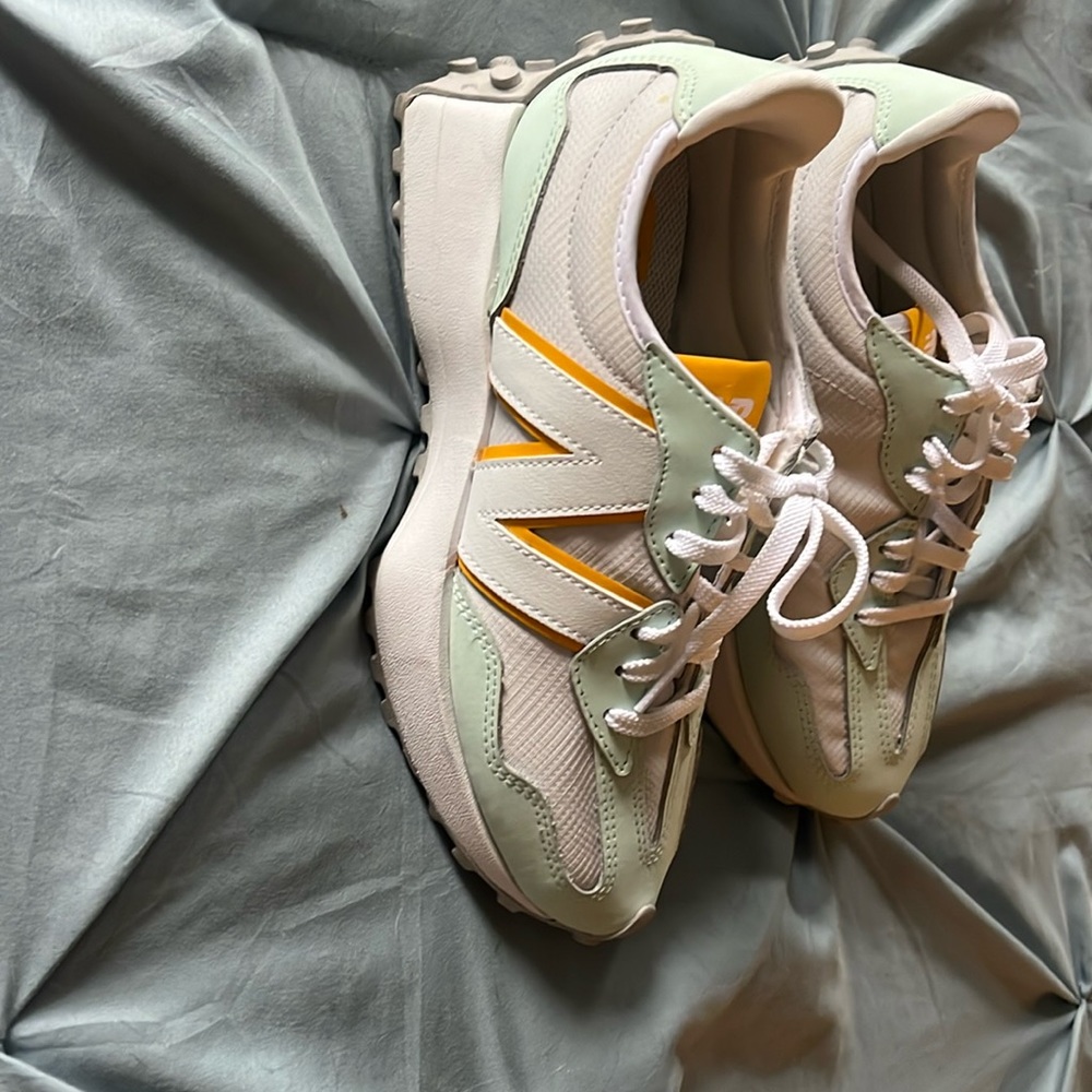 New balance 327 women’s  size 6 light blue, white, and yellow with gray bottom.